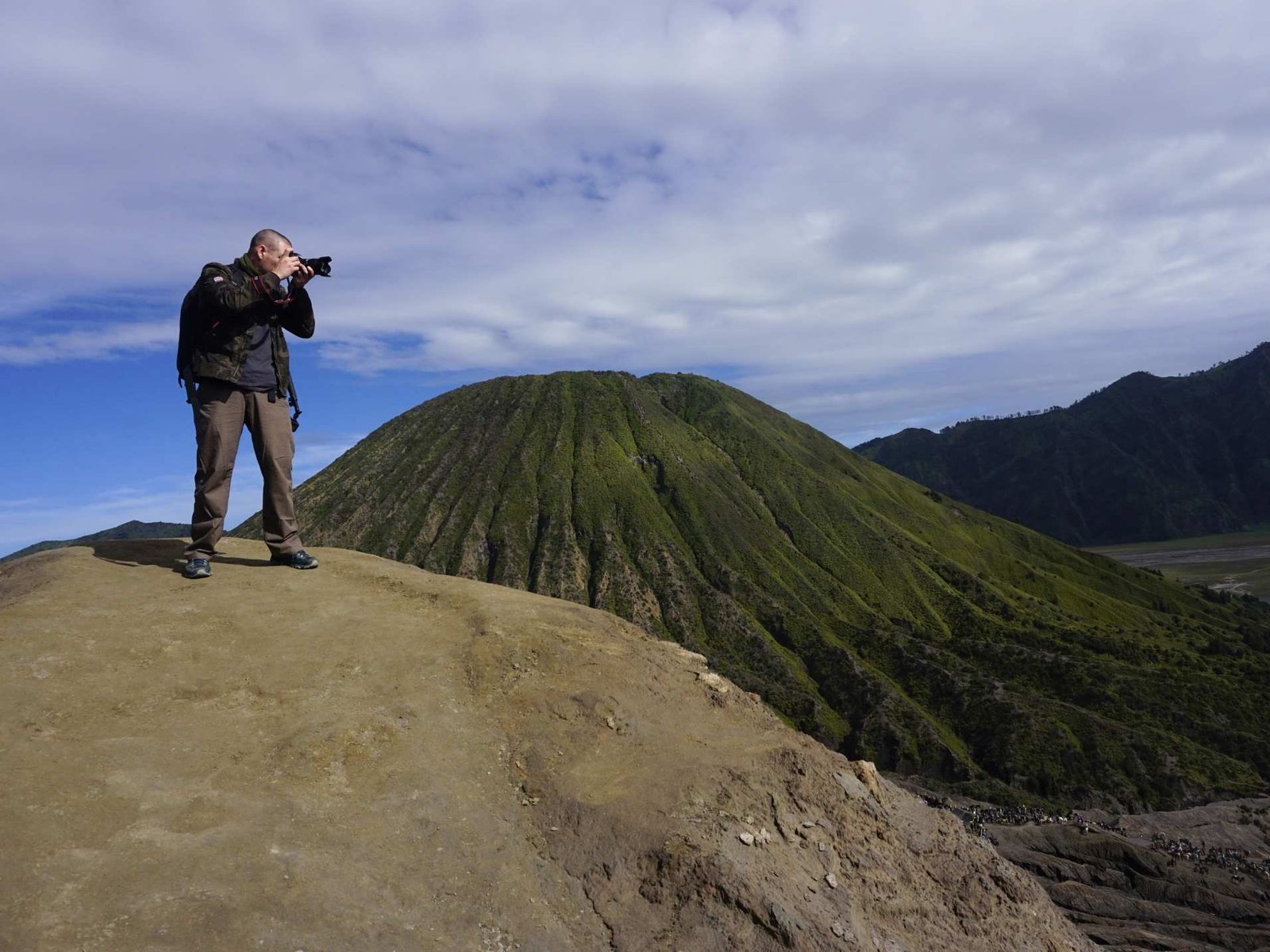 Tourists trekking stairs to Mount Bromo crater rim during sunrise tour