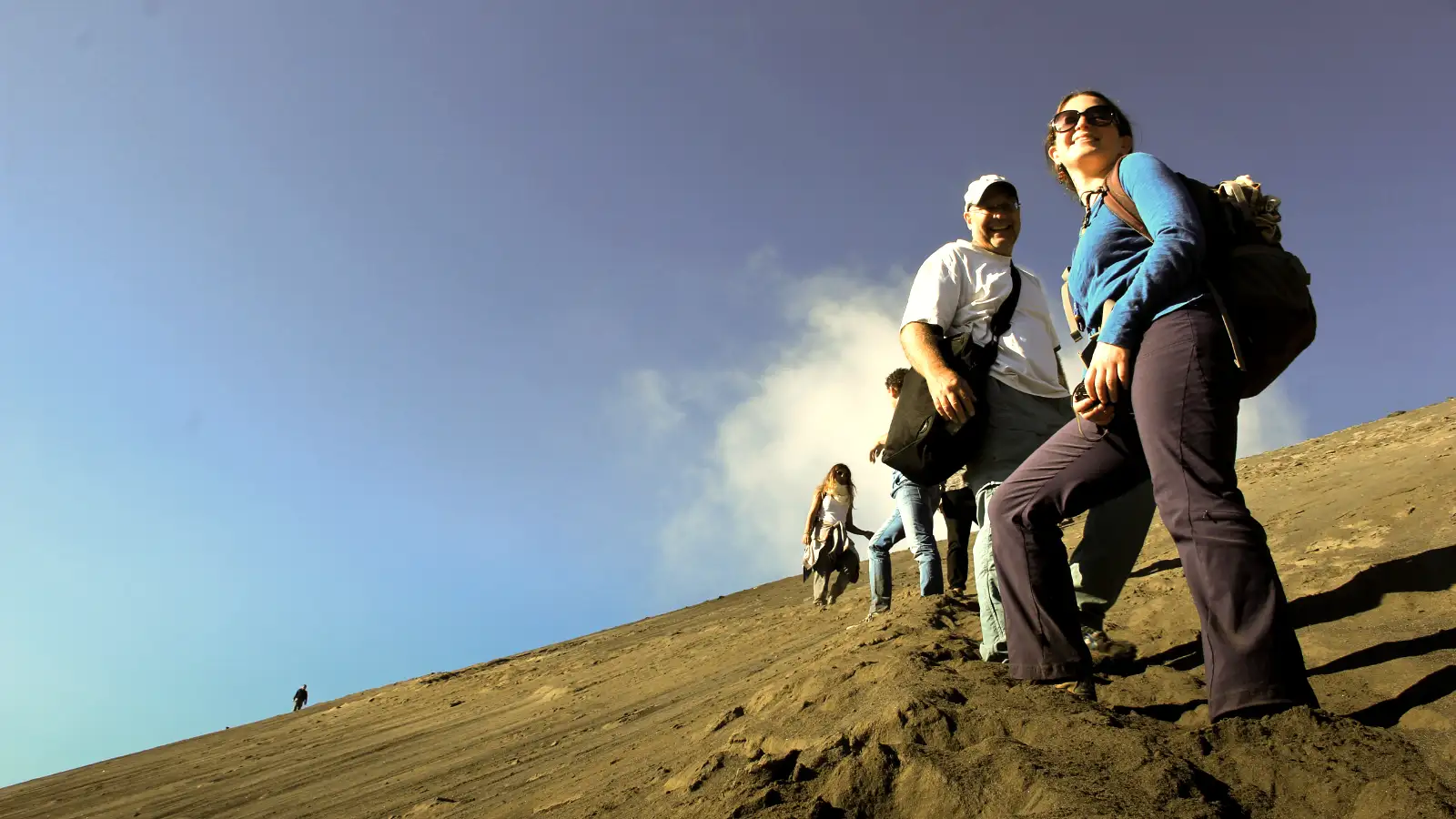 A line of colorful 4x4 Jeeps parked on the volcanic Sea of Sand near Mount Bromo